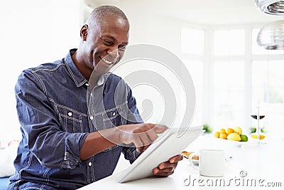 African American Man Using Digital Tablet At Home