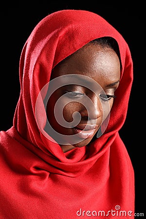 African American muslim girl in hijab looks down