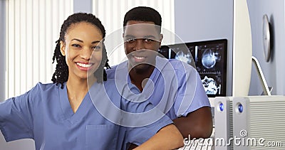 African American physicians sitting together by computer