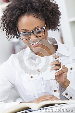 African American Woman Drinking Coffee Reading Book