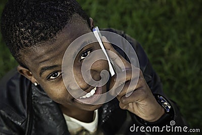 African boy on cell phone outside