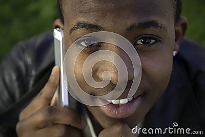 African boy on cell phone outside