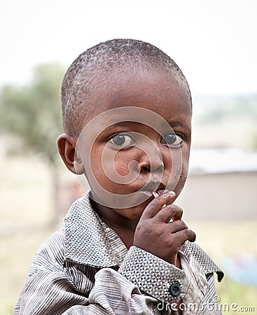 African boy of Masai tribe village looking to the camera, Tanza