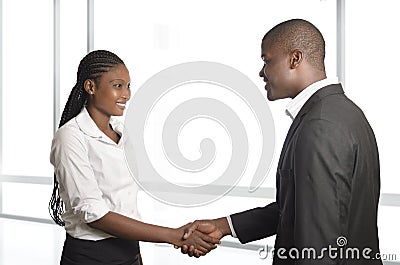 African business partners shake hands