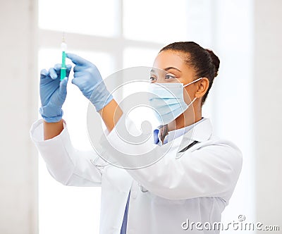 African doctor holding syringe with injection