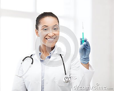 African doctor holding syringe with injection