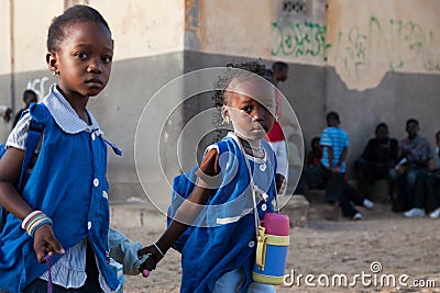 African girls dressed in blue on the way to school in Senegal