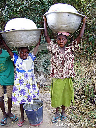 African girls taking water - Ghana