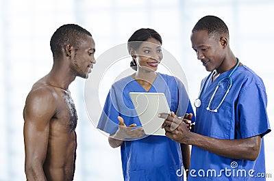 African health care team with tablet PC and patient