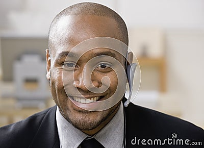 African man with hands-free cell phone device