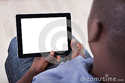 African person sitting with digital tablet
