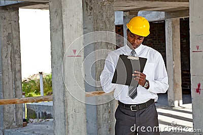 African site inspector surveying construction site