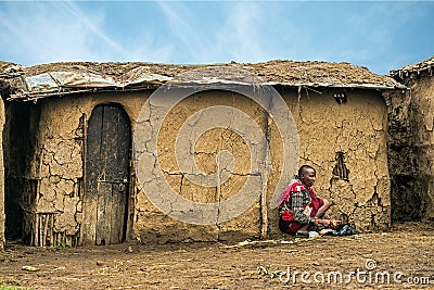 African woman from Masai tribe working in front of her village h