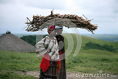 African women resting while carrying wood in South Africa