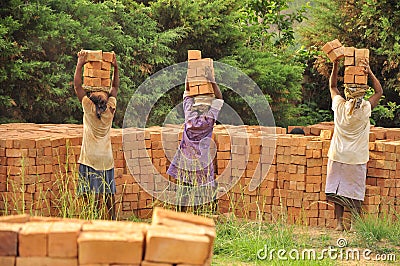 African women at work carrying bricks