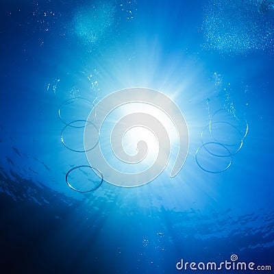 Air rings and bubbles underwater with sunshine
