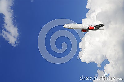 Airplane emerging from out of cloud