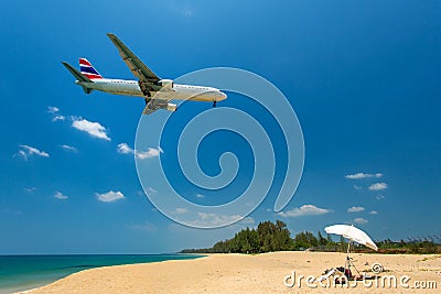 Airplane flying over the island beach