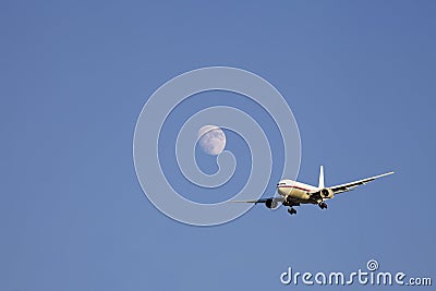 Airplane flying past the moon