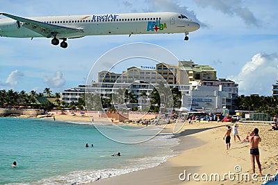 Airplane Landing over Busy Beach
