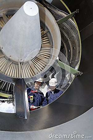 Airplane mechanics inside large jet-engine