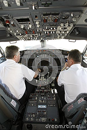 Airplane pilots in cockpit preparing to takeoff