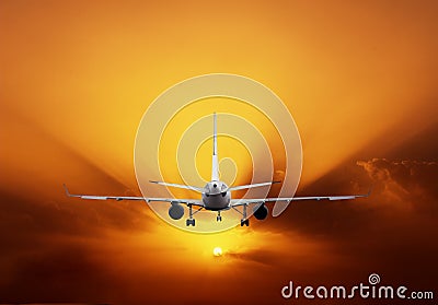 Airplane on sunset sky