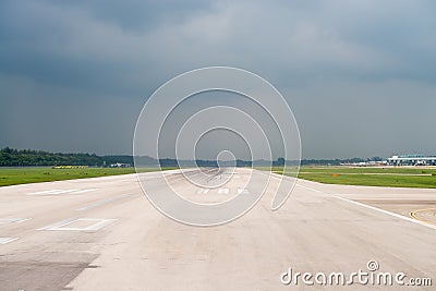 Airport runway under storm sky