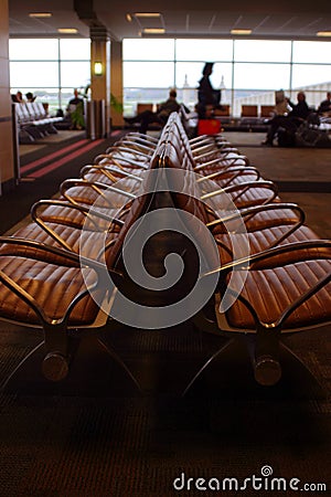Airport seating with travelers in background
