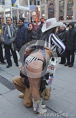 Alex, the Naked Cowgirl, entertains the crowd in Times Square during Super Bowl XLVIII week in Manhattan