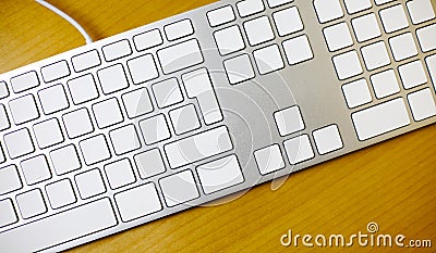 Aluminum blank keyboard on wooden desk