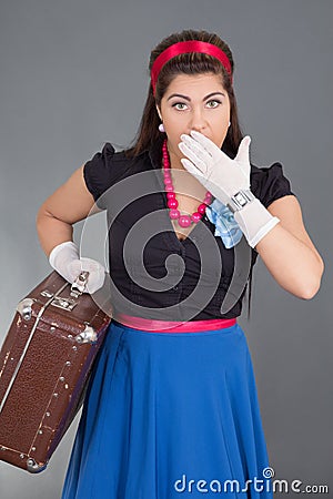 Amazed woman with retro suitcase