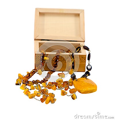 Amber jewelry and wooden box isolated on white background.