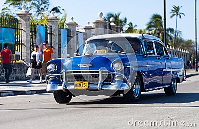 American blue classic car as taxi in havana city on the malecon