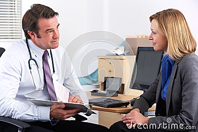 American doctor talking to businesswoman patient