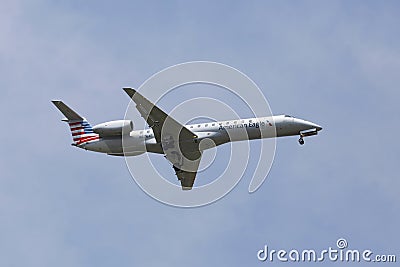 American Eagle Embraer ERJ-145 jet in New York sky before landing at JFK Airport