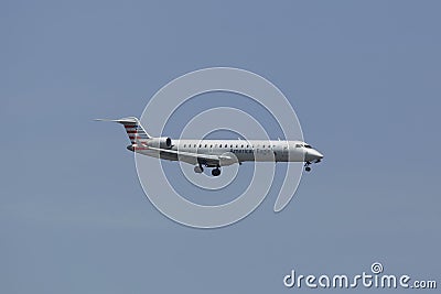 American Eagle Embraer ERJ-145 jet in New York sky before landing at JFK Airport