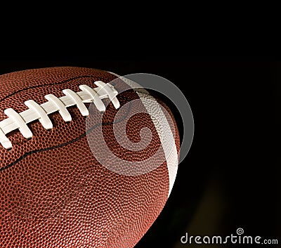 American football against a black background