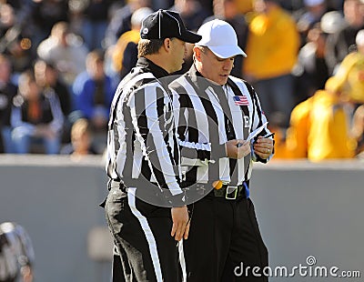American football game officials talking - referee