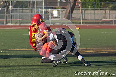 American Football Player Being Tackled During a Ga