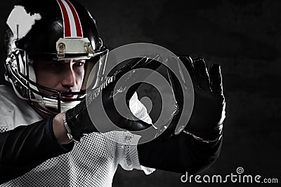 Portrait of american football player on dark background.  football background portrait