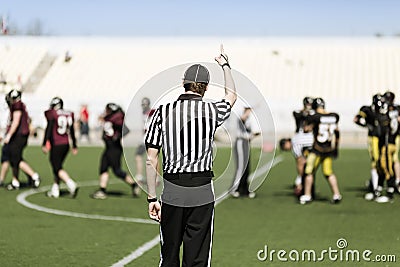 American football referee with hand up