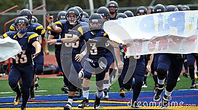 American High School football team enters field