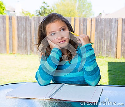 american-latin-teen-girl-doing-homework-backyard-thinking-pencil-31376287.jpg