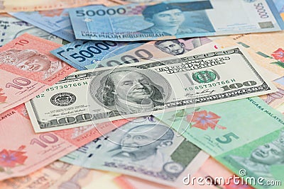 American one hundred dollar bills and Asian currencies background