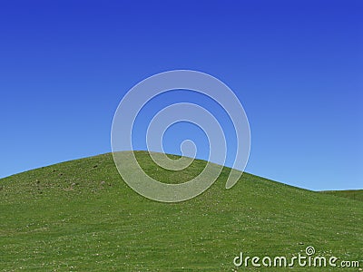 American Prairie Grass Hill over Blue Western Sky