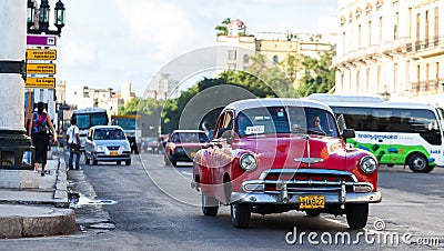 American red classic car in havana city on the street