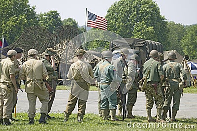 American soldiers with American flag flying