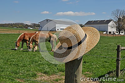 Amish hat on a farm fence post