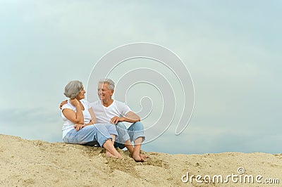 Amusing elderly couple on the beach